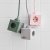Plug Kub grenuttag i grön, grå och rosa med 3 jordade eluttag, 2 USB-A och 1 USB-C.